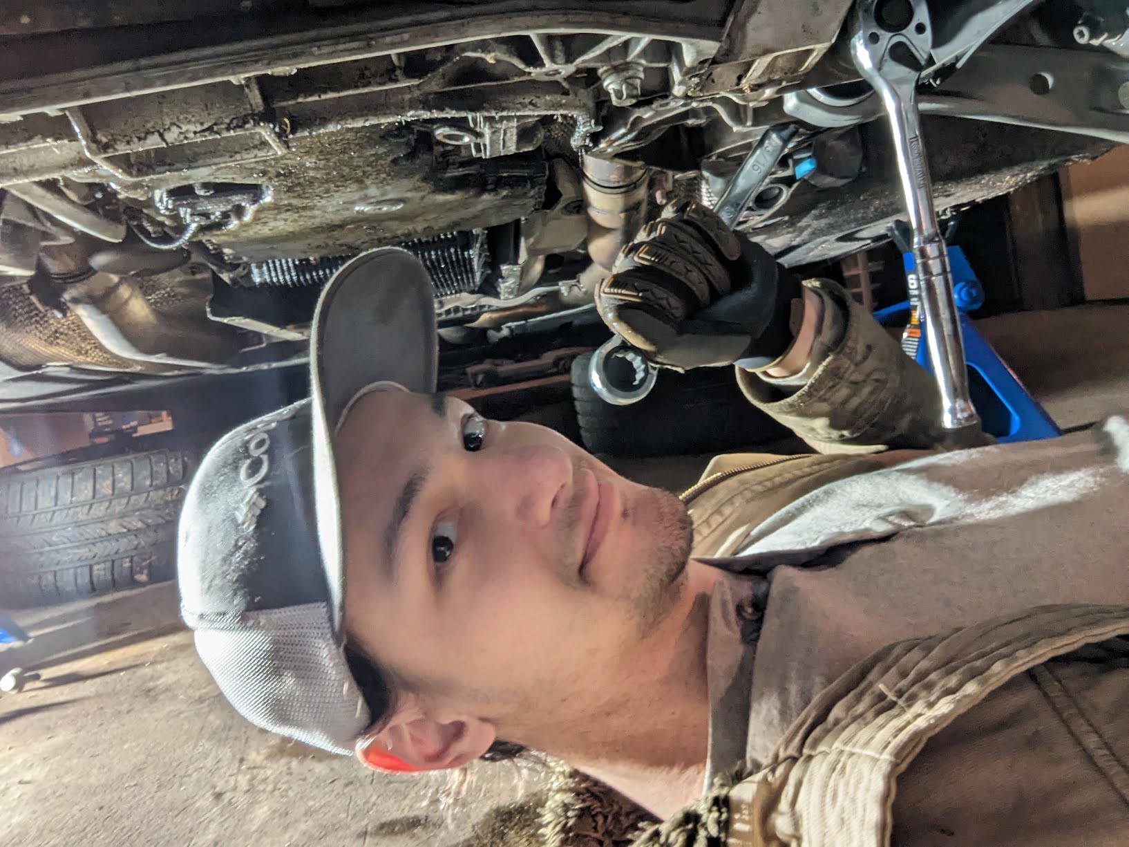 A selfie of me underneath my car, working on taking off a lower control arm. 
                              There is a 17mm